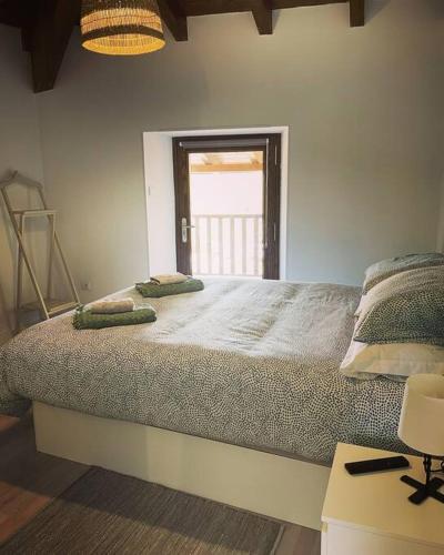 a bedroom with a large bed with two pillows on it at Casa Vilar (Taboadela-Ourense) in Taboadela