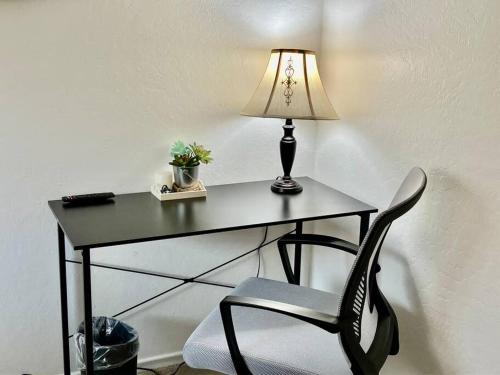 a black desk with a lamp and a chair at Charming Townhouse w/ Yard + BBQ in San Jose