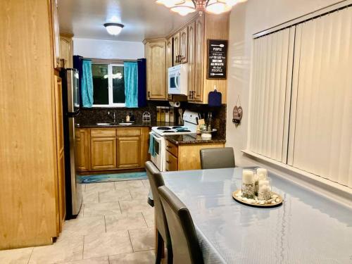a kitchen with a table with chairs and a counter top at Charming Townhouse w/ Yard + BBQ in San Jose