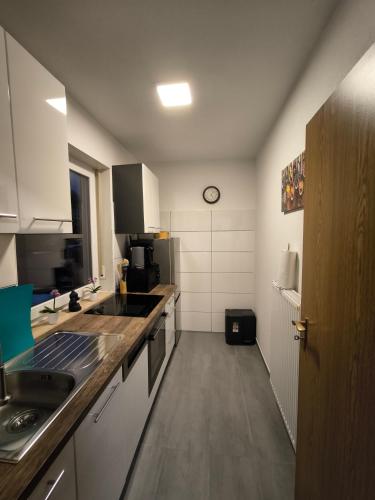 a kitchen with a sink and a counter top at Haus am ruhige Lage in Langscheid Nähe sorpesee in Melschede