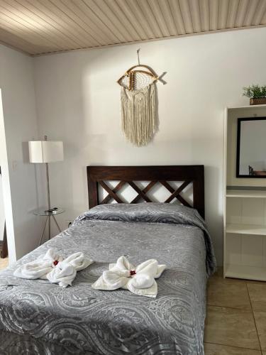a bedroom with towels on a bed with a tv at Alojamientos N&S in Fortuna