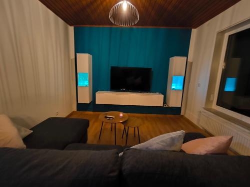 a living room with a couch and a television at Haus am ruhige Lage in Langscheid Nähe sorpesee in Melschede