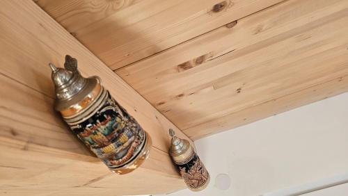 a bottle on top of a wooden table at Christians Alpenparadies in Bad Mitterndorf