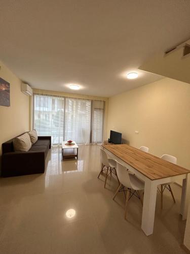 a living room with a table and a couch at Lighthouse Golf & Spa Resort F79 in Balchik
