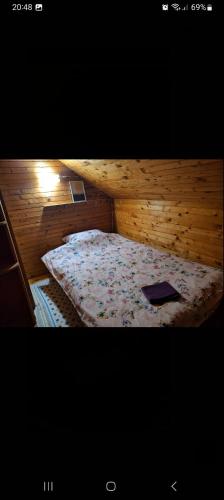 a bedroom with a bed in a wooden room at Vikendica Savic TKM in Pale