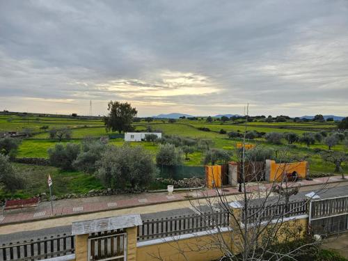 a view of a field with a fence and a road at Casa Alegria in Abertura