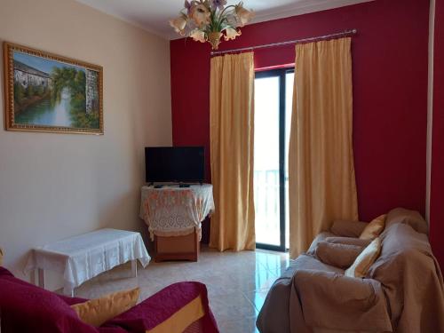 a living room with a couch and a tv at Spacious apartment in Marsalforn, Gozo in Marsalforn