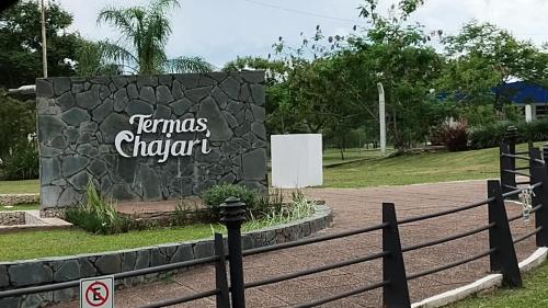 a sign for a dinosaur park with a fence at Naturaleza Termal in Chajarí