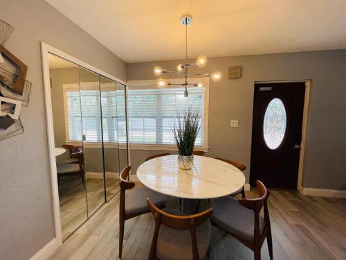 a dining room with a table and chairs and a window at Sarasota Paradise Heated Pool Home Near IMG & Siesta Key Beach in Sarasota