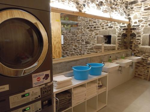 a bathroom with two sinks and a large microwave at Abeiro da loba in Madelos