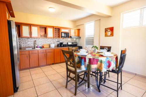 a kitchen with a table and chairs in a room at Colinas del Atlantico Vacational House 1st floor in Isabela