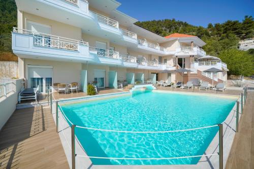 a large swimming pool in front of a building at Sunny Hotel Thassos in Chrysi Ammoudia