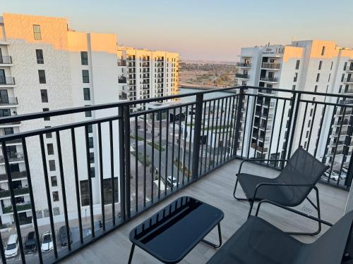 a balcony with two chairs and a view of buildings at Charming Yas Island Stay with Balcony in Abu Dhabi