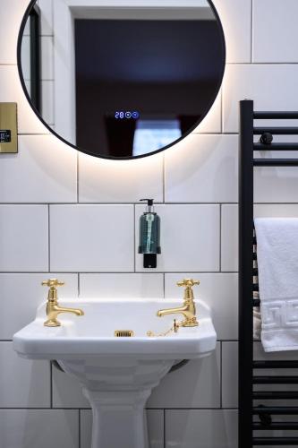 a bathroom with a sink and a mirror at Queen Charlotte Guesthouse in Edinburgh