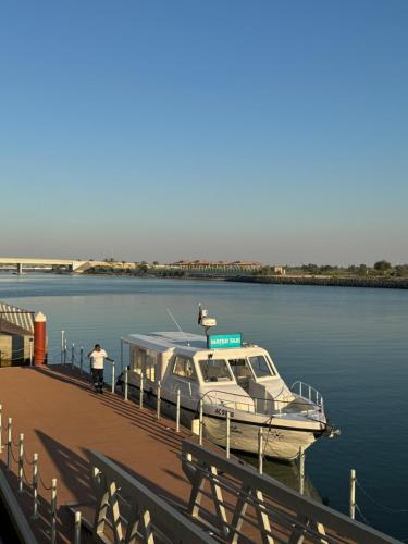 a boat is docked at a dock on the water at Charming Yas Island Stay with Balcony in Abu Dhabi