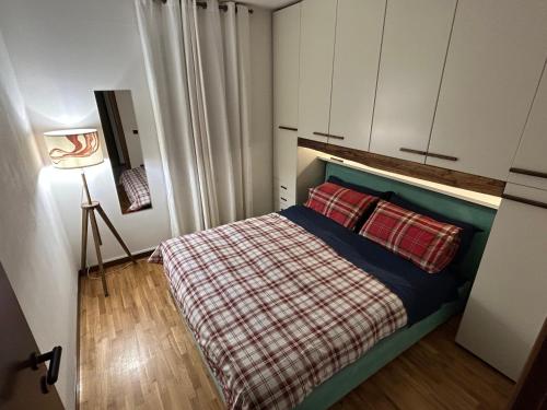 1 dormitorio con 1 cama con 2 almohadas rojas en *St. Bart*, en Aprica