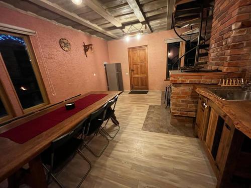 a kitchen with a counter and a bar with stools at Pirts māja Lilijas in Baldone