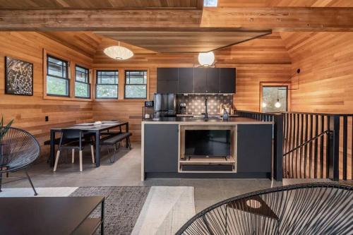 a kitchen with a stove and a dining room at Oregon Coast Modern at Neahkahnie Beach in Nehalem