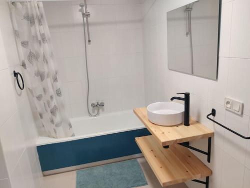 a bathroom with a sink and a bath tub at La Casa de Boo in Boó de Piélagos