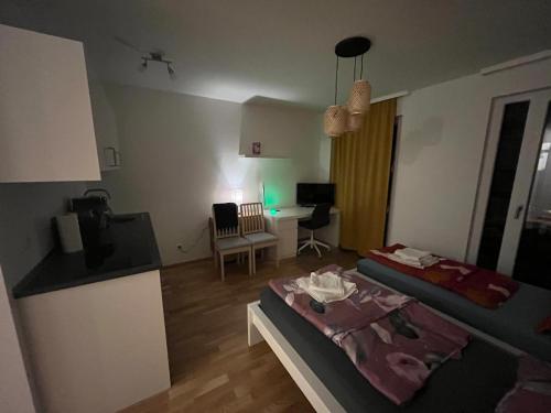 a small room with two beds and a desk at New Business Apartment Nr.21 in Dresden