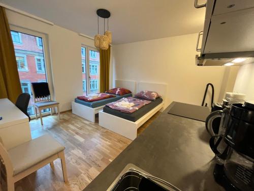 a kitchen and living room with a couch and a bed at New Business Apartment Nr.21 in Dresden