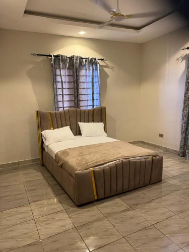 a large bed in a room with a window at Fowaa Lux in Tema
