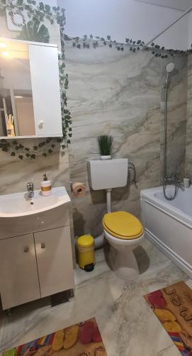 a bathroom with a toilet and a sink and a tub at Marble Studio in Bucharest