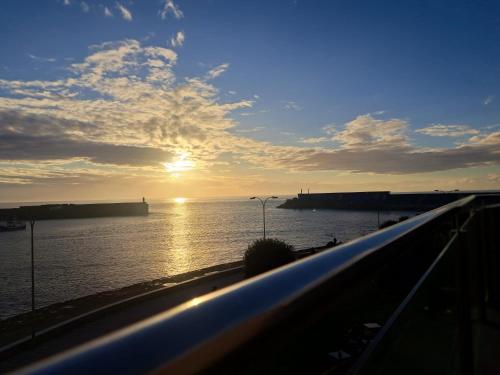 a view of the ocean with the sun in the sky at Malecón Guardes in A Guarda