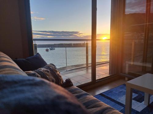a couch in a living room with a view of the ocean at Malecón Guardes in A Guarda