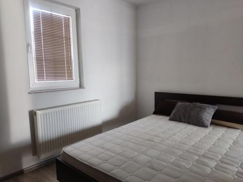 a bedroom with a bed and a window at Selma in Vogošća