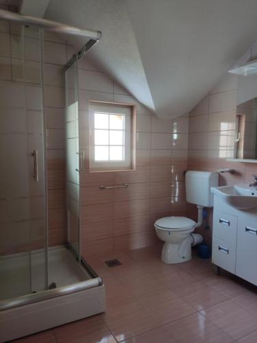 a bathroom with a toilet and a shower and a sink at Selma in Vogošća