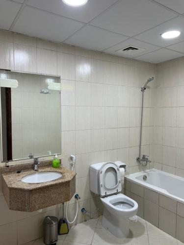 ein Badezimmer mit einem WC, einem Waschbecken und einer Badewanne in der Unterkunft Ft 30f R2 SeaView Room at Beach with separate bath in Ajman 