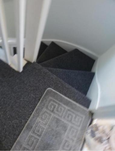 a stairway with a sticker on the floor next to a door at Fresher Space Home Stay in Birmingham