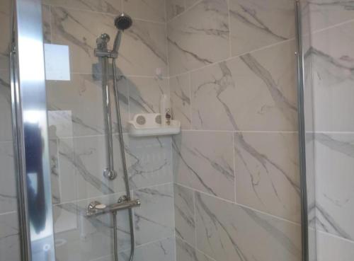 a bathroom with a shower with a glass door at Fresher Space Home Stay in Birmingham