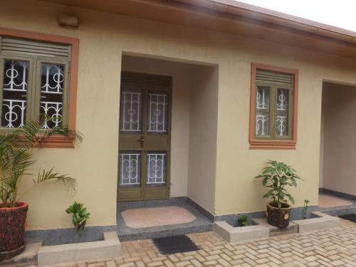 a house with plants in front of it at Malaika Apartments Uganda in Kampala