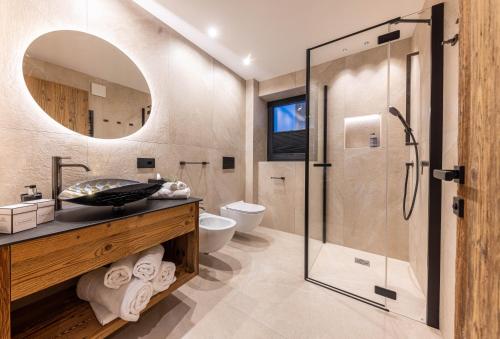 a bathroom with a glass shower and a sink at Enjoy Dolomites - Chalet in Santa Cristina Gherdëina