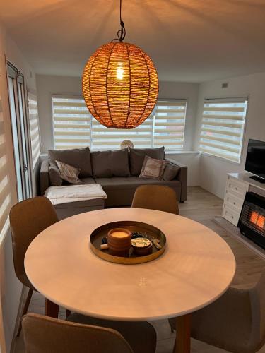 a living room with a table and a couch at Chalet Quattro in bosrijke omgeving in Anloo