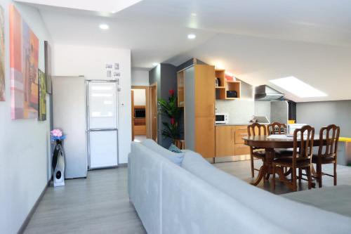 a living room and kitchen with a couch and a table at Quinta da Bandeira - Casa de Férias no Douro in Mártir