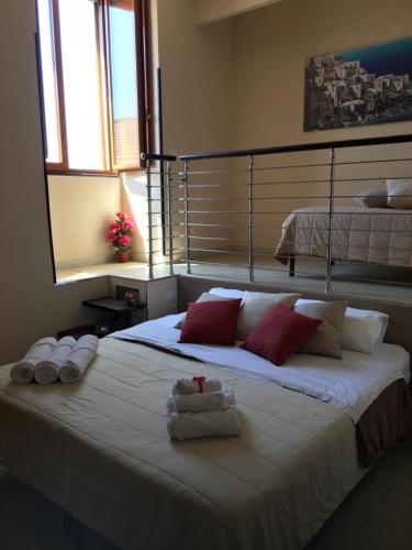 a bedroom with a large bed with towels on it at O'Presidente B&B in Gragnano