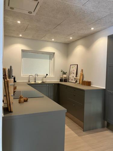 a large kitchen with a sink and a window at GuestHouse Læsø in Vesterø Havn