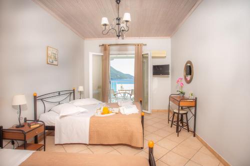 a bedroom with a bed and a view of the ocean at Romanza Studios in Vasiliki