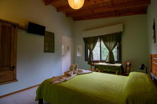 Postel nebo postele na pokoji v ubytování El Viejo Algarrobo - Hosteria Serrana