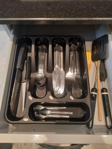 a drawer in the stove with utensils in it at Les jardins du lac 2 in Tunis