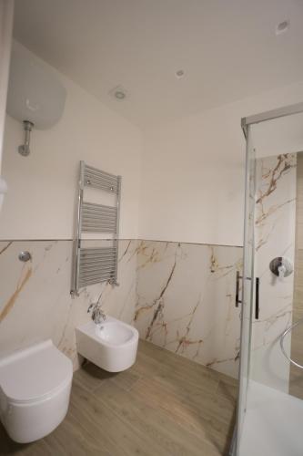 a white bathroom with a toilet and a sink at B&B Nonna Maria in Pompei