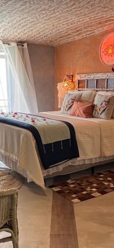 a bedroom with a large bed in a room at Villa Lulu Geribá in Búzios