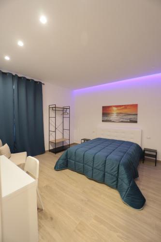 a bedroom with a large bed with a blue blanket at B&B Nonna Maria in Pompei