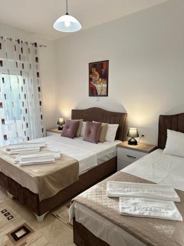 two beds in a room with two beds sidx sidx sidx at Apartments Sija in Ulcinj