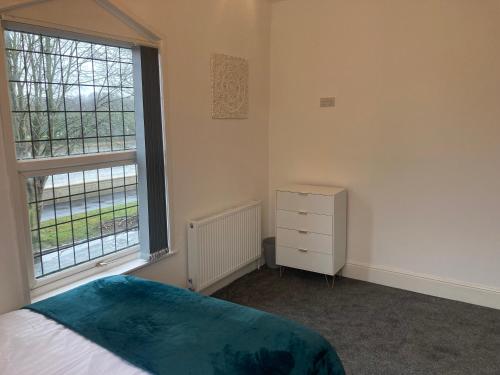 a bedroom with a bed and a large window at Riverside by Teil in Preston