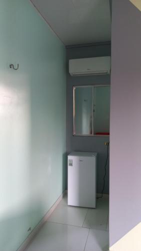an empty room with a white refrigerator in a room at Pousada Carvalho in Salinópolis