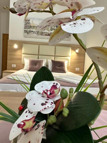 a bunch of white flowers in a room with a bed at Apartments Sija in Ulcinj